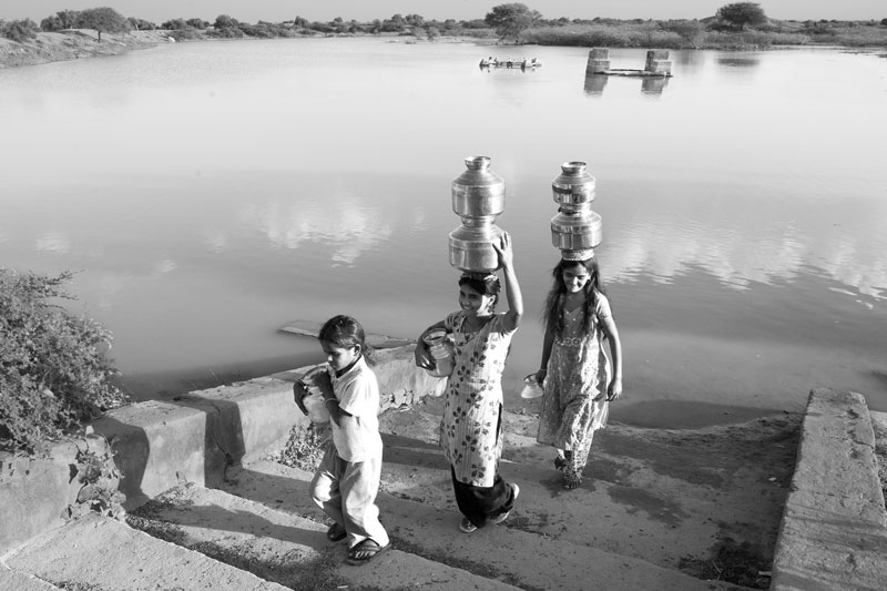 Traditional water supply science and technology of India - Girls fetching 'sweet' water from a pond in Kutch district, Gujarat